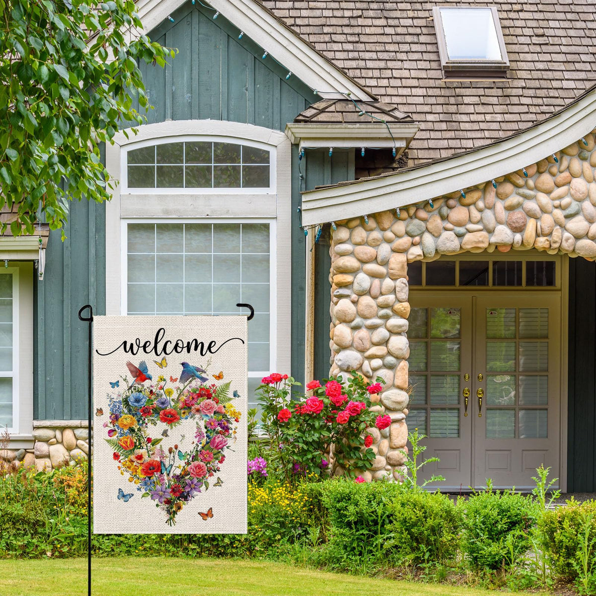 Wyooxoo bird and floral design flag enhances garden ambience.
