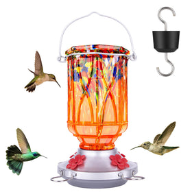 XAROO hand-blown orange hummingbird feeder glows in sunlight, attracting birds.