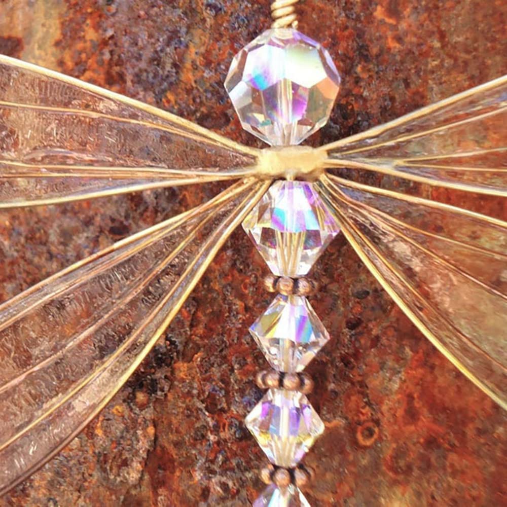 XinTX Dragonfly crystal suncatcher on a bedroom windowsill with soft light