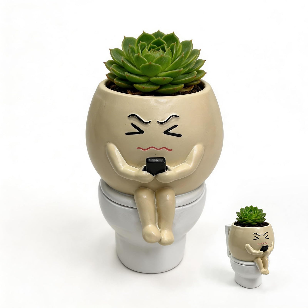 Xoevlix toilet-face planter on a desk adds playful charm to home or office.