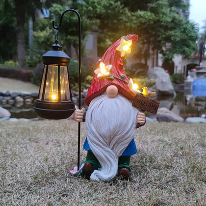 Yardancer solar gnome garden-lantern lights the yard at dusk