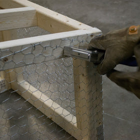 Coop setup with netting showing quick, easy attachment around a chicken coop