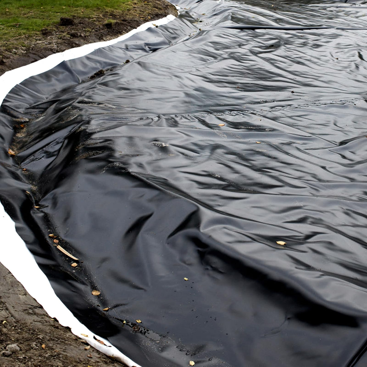 Yarlung pond liner underlayment providing a flat base for water features