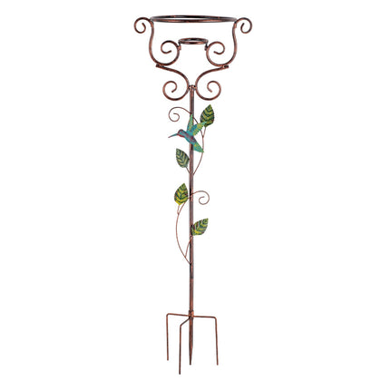 YELENEW gazing ball stand with four-prong base framed by hummingbird vines in a garden.