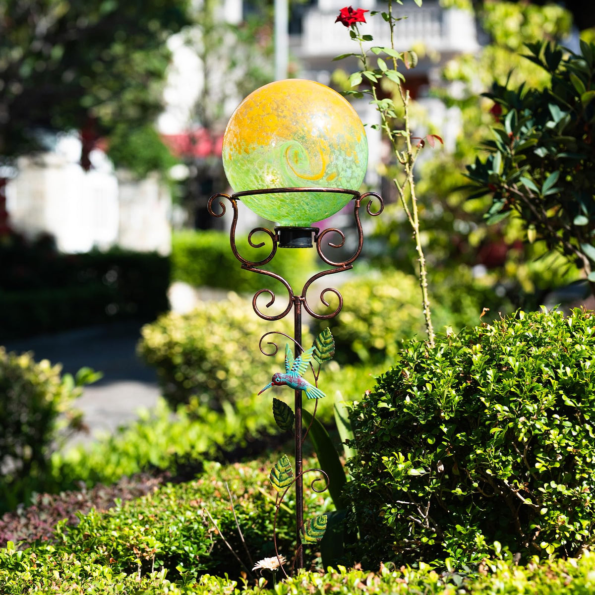 YELENEW stand holding a glass sphere for patio presentation.