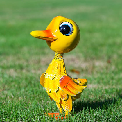 YELENEW yellow duck garden statue gleams in sunlight, adding whimsical curb appeal.