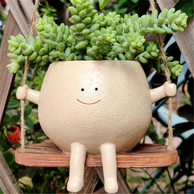 YGGlDUOl Resin Swing Planter close-up showing durable material and playful smile