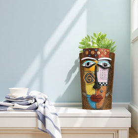 Yhupl Picasso face pot on window sill brightens shelves with color
