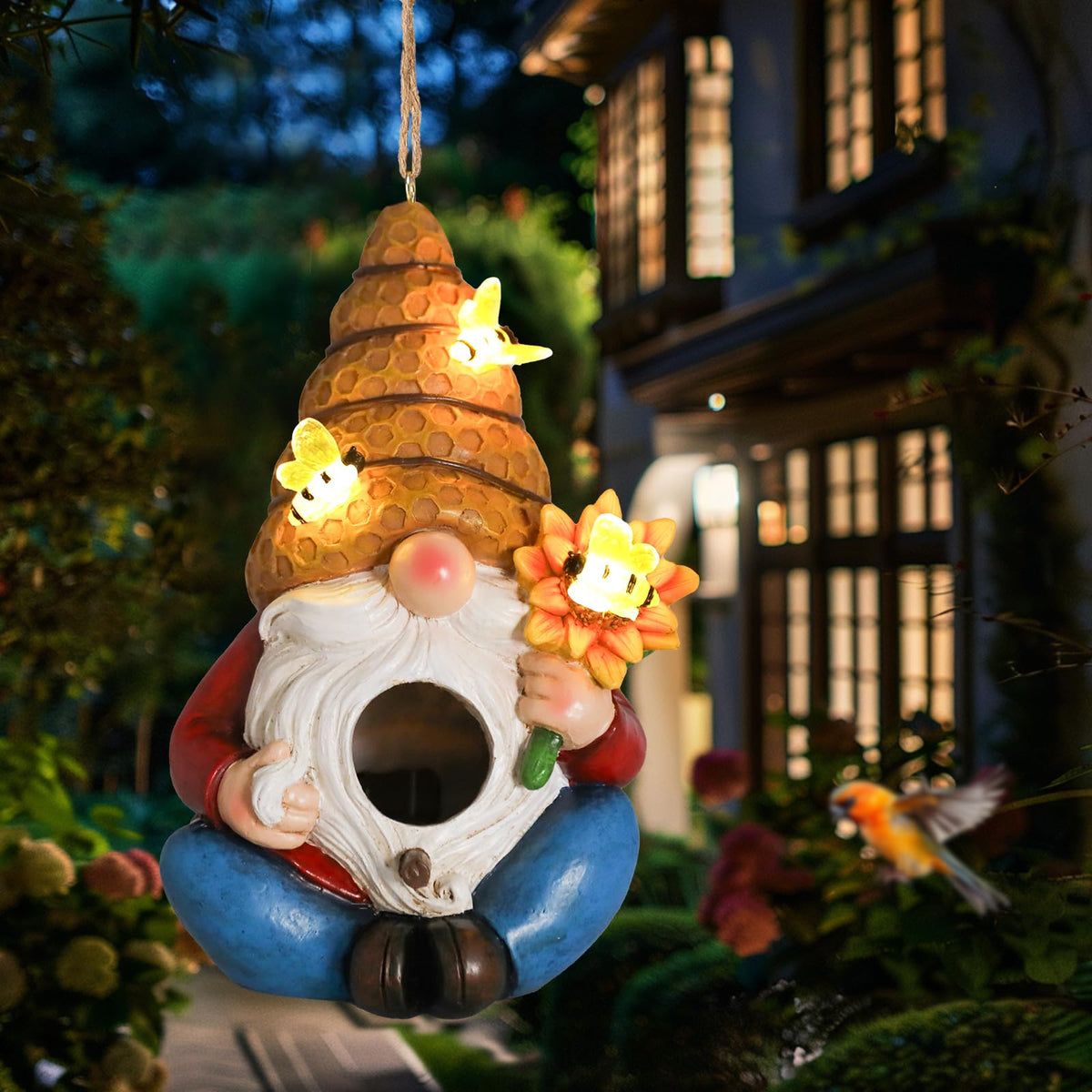 Yinns Bird House outdoor hanging decor in a garden setting, attracting small birds.