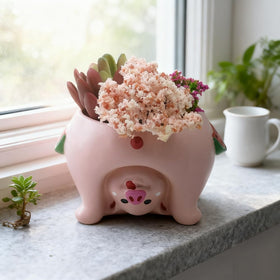 Youfui pig planter detail shows rubber stopper for tidy watering.