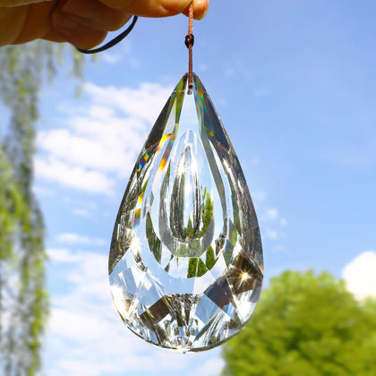 Yu Feng 5-inch crystal prism suncatcher catching sunlight and creating vibrant rainbow reflections.