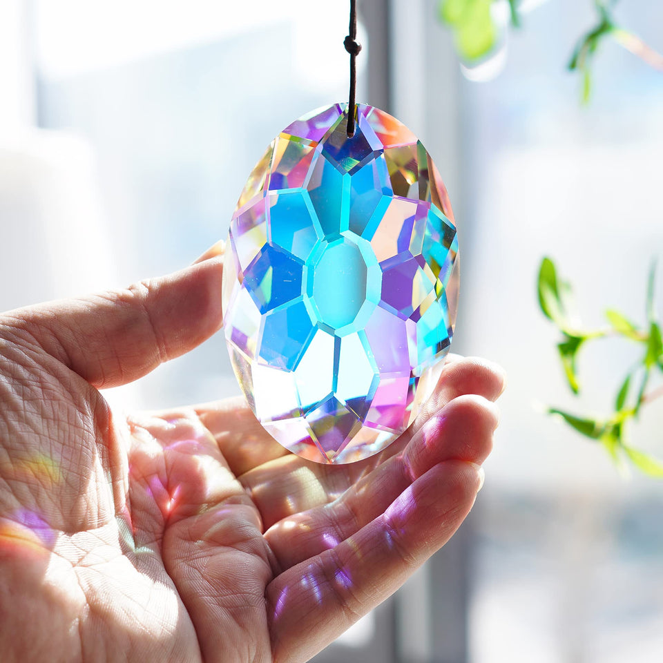 YU FENG AB coating crystal prism hanging in a sunlit window creates vivid rainbow reflections.