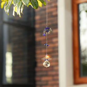 YU FENG car rearview suncatcher prism ball casts rainbow sparkles.