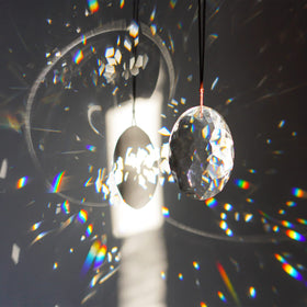 Closeup facets of YU FENG prism scatter light into sparkling prisms