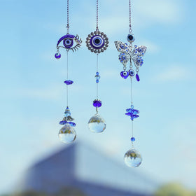 YU FENG evil eye suncatcher prism ball set catching sunlight to color your room.