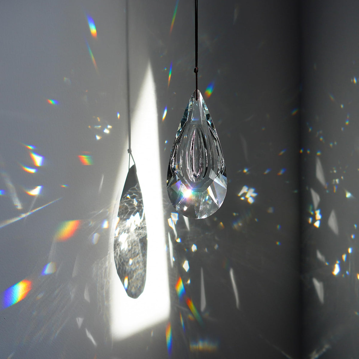 Yu Feng window suncatcher hangs easily to cast colorful light indoors.