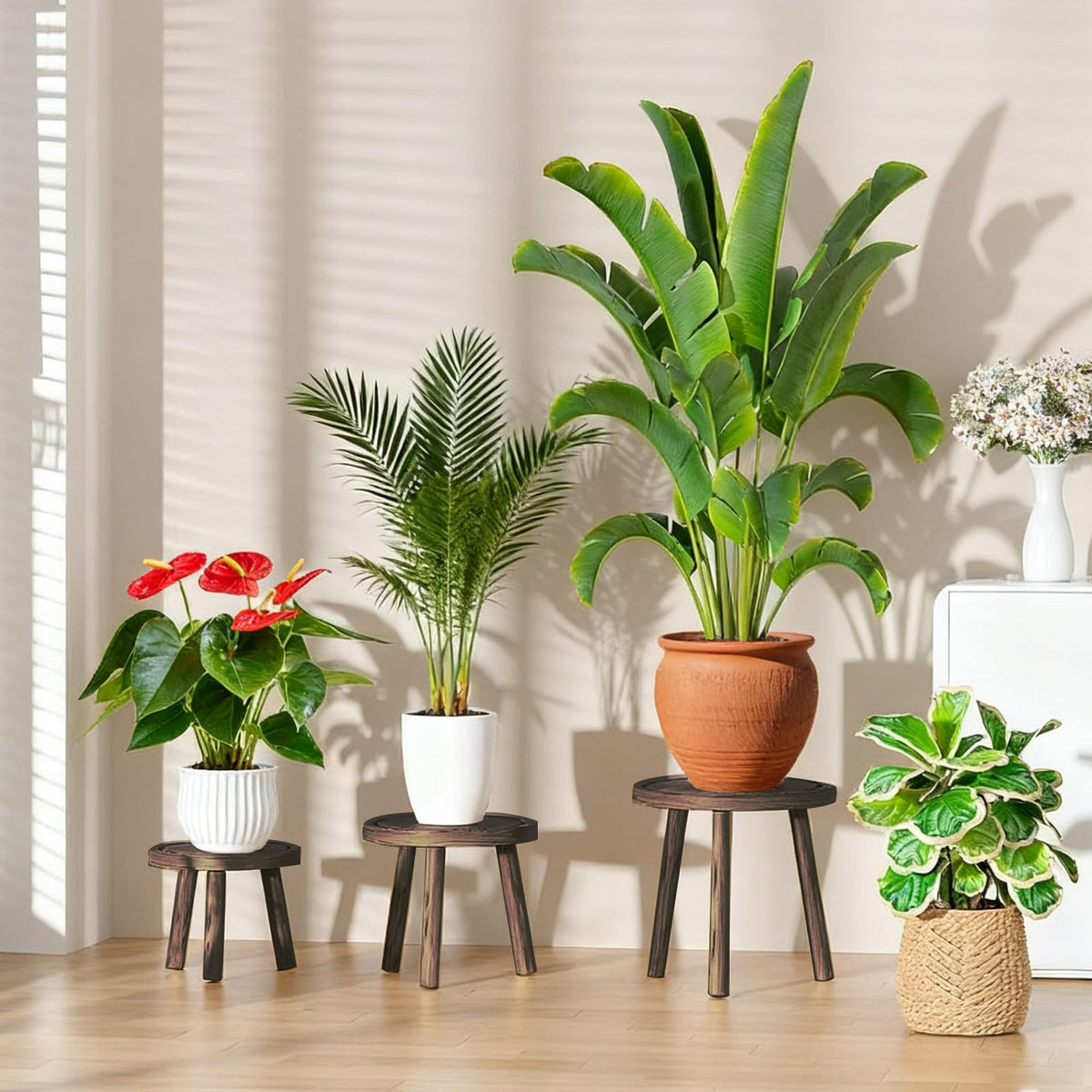 YUZUKYAUY mid-century wooden plant stools highlight layered plant arrangements.