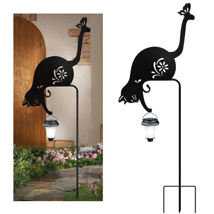 YY-Ladybug cat holding solar lantern stake glows softly in the garden at dusk