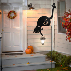 YY-Ladybug cat holding solar lantern stake installation in a yard