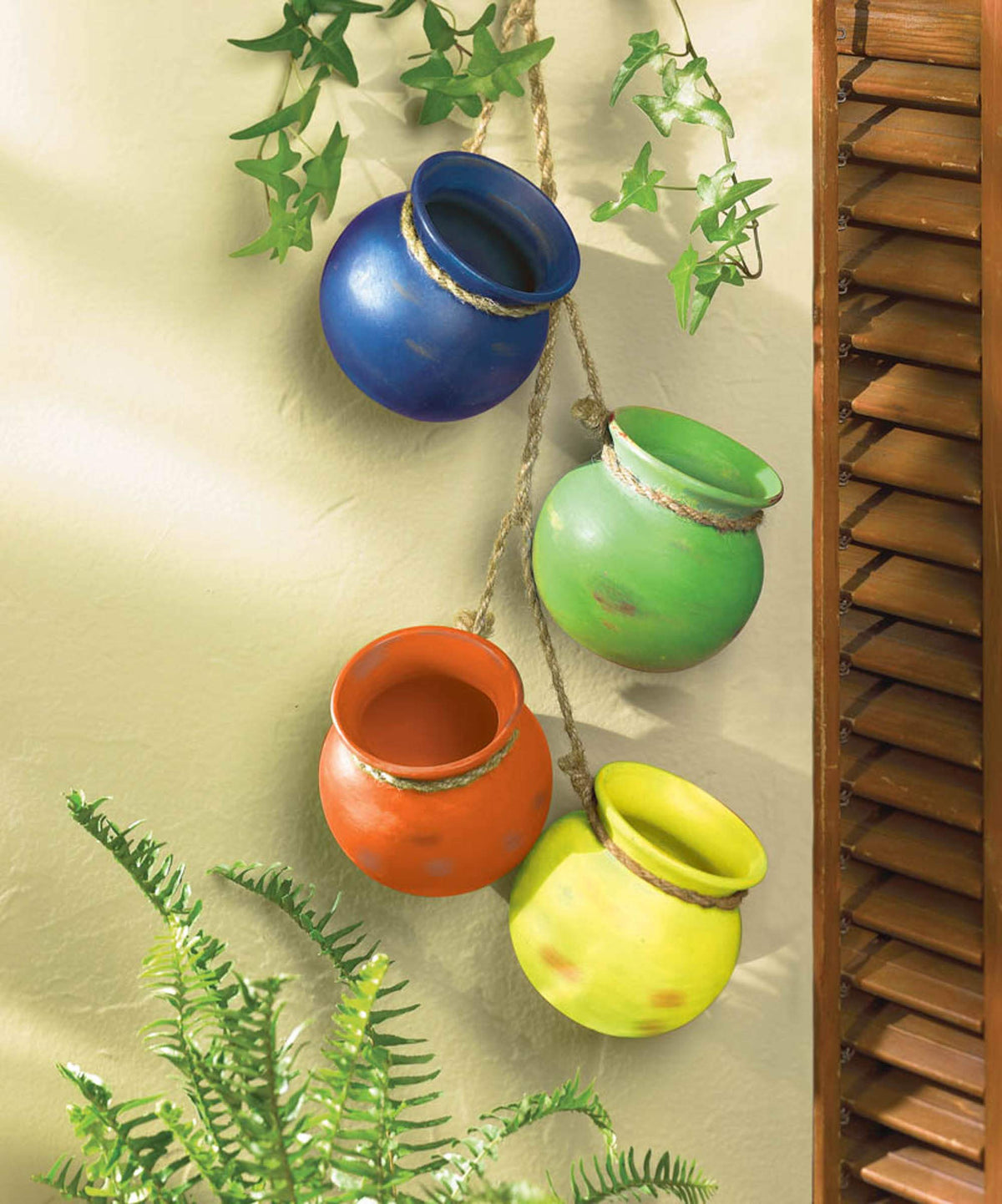 Zingz & Thingz green dangling terracotta planter brings fresh greenery to sunrooms or balconies.