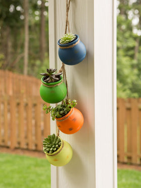 Zingz & Thingz orange dangling terracotta planter injects warmth for patios and kitchens.