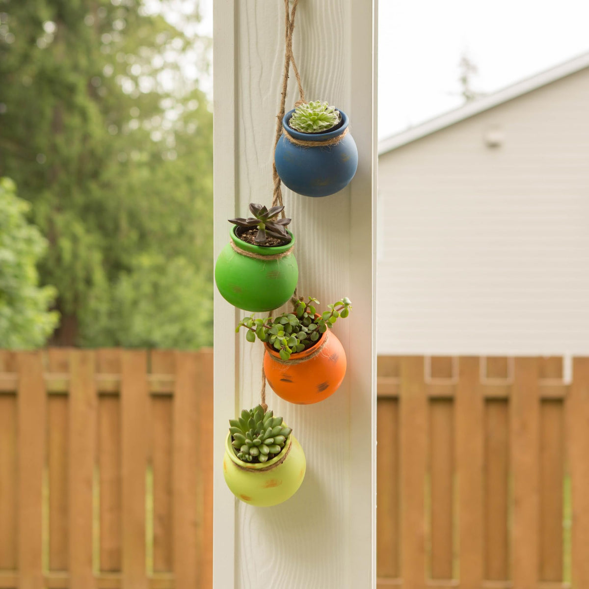 Zingz & Thingz yellow hanging terracotta planter provides cheerful accents for entryways or gardens.