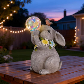 zuzuzen Solar Rabbit Statue glows at night for ambient outdoor lighting.